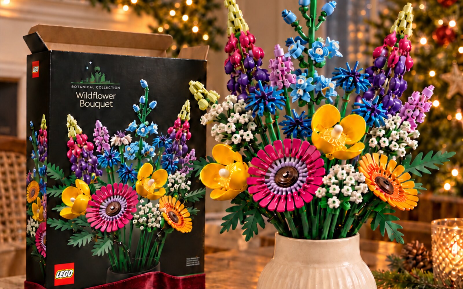 LEGO Botanicals Wildflower Bouquet displayed beside its box in a warm Christmas setting